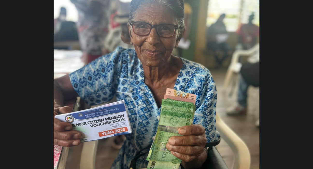 An image of an elderly woman holding cash