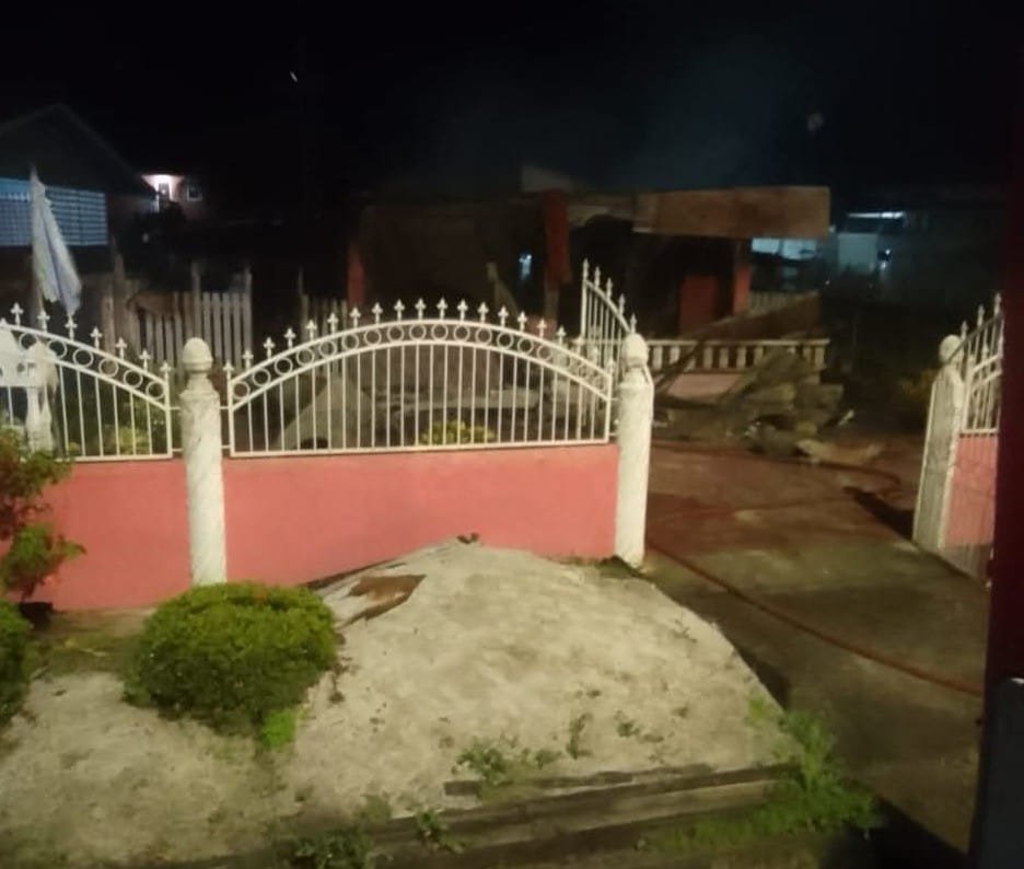 A preliminary investigation into the deadly fire at Lot 1 A Hydronie, East Bank Essequibo, this morning has determined that the blaze was caused by a slack electrical connection. The faulty connection led to arcing and sparking, igniting nearby combustible materials and ultimately engulfing the home of Hansraj Narine, 57, and Hemwattie Narine, 52, in the early hours of 9 February 2025. Home Affairs Minister, Robeson Benn, and Chief Fire Officer Gregory Wickham have since expressed their deep condolences to the grieving family and the community. Minister Benn also assured that a full investigation is ongoing to determine all contributing factors and to prevent future occurrences. The fire, which broke out around 01:55 hrs, completely destroyed the 15m x 8m wooden and concrete structure. The Guyana Fire Service arrived on the scene at 02:16 hrs, but the fire had already spread too quickly, leaving no time for the occupants to escape, a release said. Firefighters, it added, immediately worked to extinguish the flames, but the home and all its contents were lost. Chief Fire Officer Wickham emphasised the critical importance of fire safety and electrical maintenance, urging all citizens to take necessary steps to safeguard their homes and families.