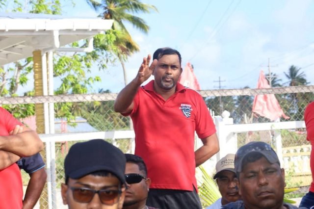 A rice farmer makes at point at the meeting