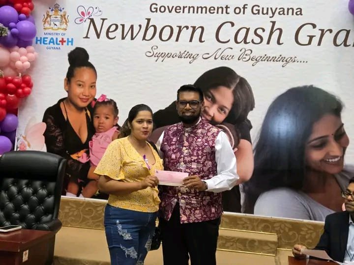Aranza Krishna receiving her cheque from President, Dr. Irfaan Ali