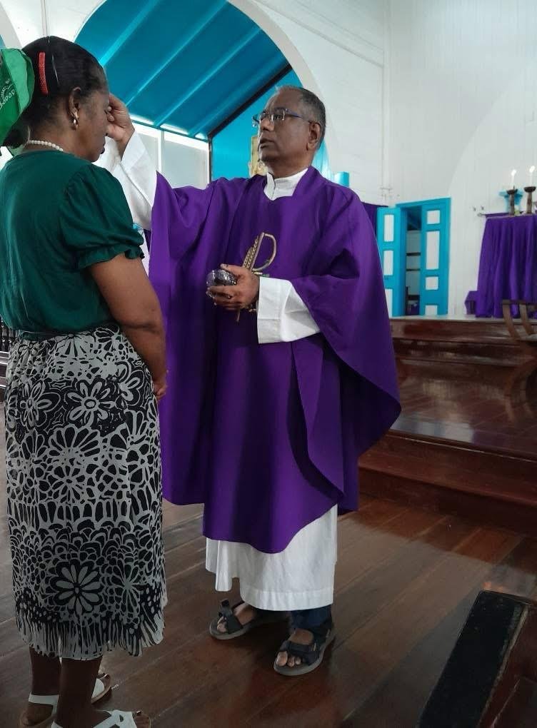 Ashes being placed on the forehead of a worshipper. Photo courtesy of St. John the Baptist Roman Catholic Church, Plaisance