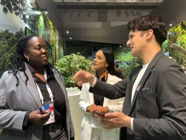 A Go-Invest staff interacts with a visitor