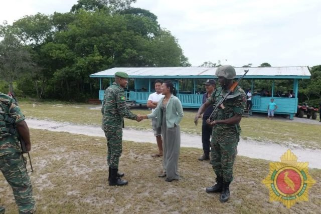 Brigadier Khan is greeted by a resident 