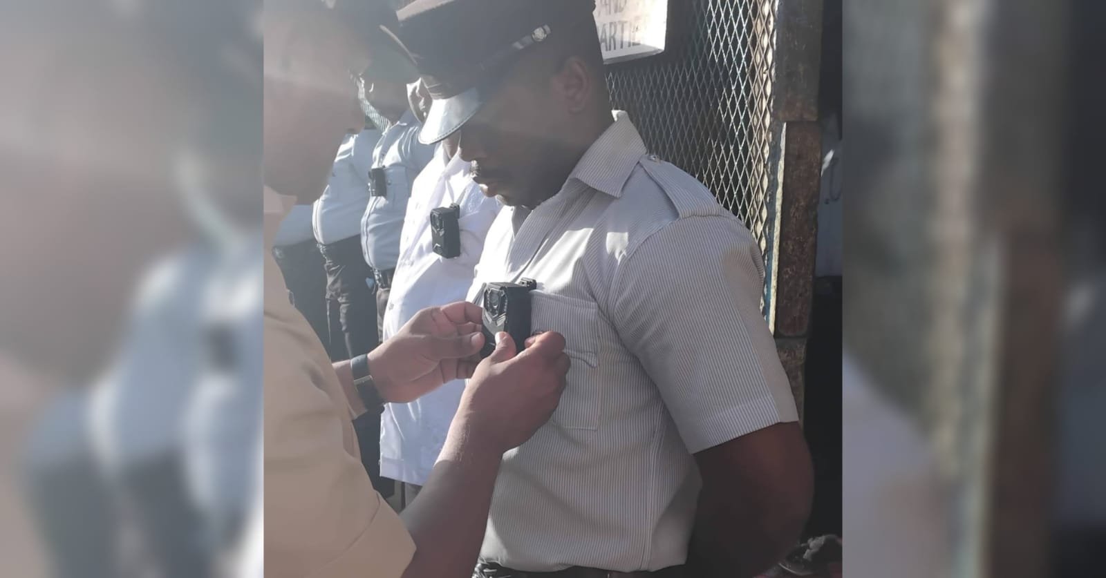 A camera being pinned on a prison officer