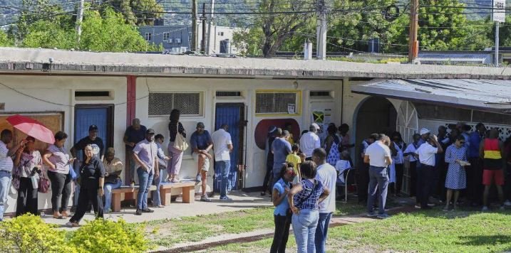 People stand in line to vote at a polling station in Jamaica (AP photo)